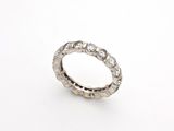a close up of a diamond ring on a white surface