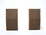 pair of speakers on a white surface with a white background