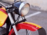 a red and yellow motorcycle parked in a parking lot