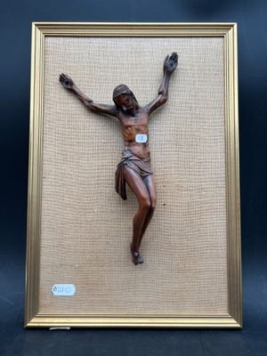 a close up of a framed picture of jesus on a cross