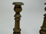 pair of antique brass candlesticks on a white background