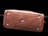 the brown leather wallet is sitting on a black surface