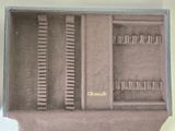 a box with a bunch of brushes inside of it