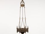 an antique brass hanging light fixture with a chain and a light bulb