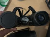 a person holding a pair of binoculars on a table