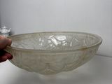 a person holding a glass bowl on a table