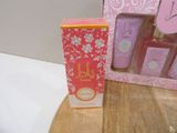 a pink box and a pink and white box on a wooden table