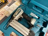 a blue case with a stapler and a stapler in it