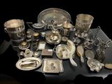 a table with a lot of silver items on it