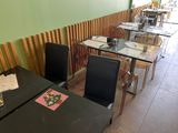 many tables and chairs in this restaurant with a menu on the table