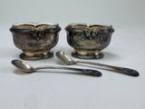two spoons and a bowl sitting on a table