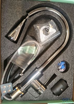 a box with a hose, a hose, and other items in it