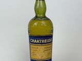 a close up of a bottle of whisky on a white surface