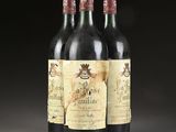 three bottles of wine sitting on top of a table next to each other