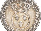 a close up of a coin with a crown on top of it