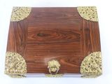 a wooden box with gold decorations on it