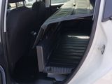 a white car with the door open and the back door open