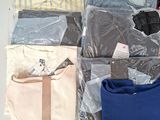 a lot of clothes that are sitting on a table