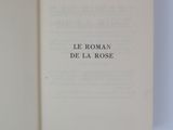 an open book on a white surface with a black writing on it