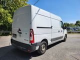 a white van parked in a parking lot with trees in the background