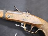 an old gun that is on display on a table