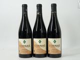 three bottles of wine sitting on top of a white table