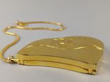 gold plated heart shaped locke with a chain on a white surface