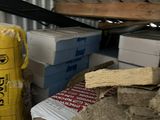 a pile of boxes and a bag of cement in a room