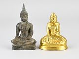 pair of gold and silver buddha figurines on a white background