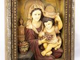 an image of a statue of a woman holding a child