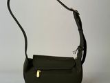 a black purse with a gold clasp on the handle