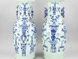 pair of blue and white vases with oriental designs on them