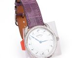 wrist watch with purple leather strap and diamond bezeled bezel