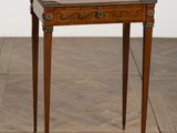 an antique wooden table with a tray on top of it on a wooden floor
