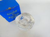 a small glass bowl sitting next to a blue box on a table