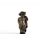 bronze figurine of a man with a hat and a cane