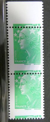 deux timbres représentant le visage d'une femme, posés sur une table