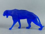 a blue figurine of a leopard on a white surface