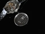 a watch that is sitting next to a coin