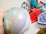 a person holding a blue and white ball in their hand