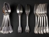 a set of five silverplated forks and spoons on a black background
