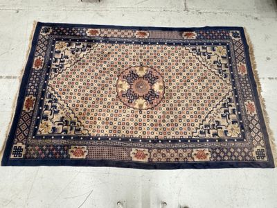 a rug on the floor with a person standing next to it
