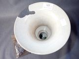 a white bowl with a hole in the middle of it