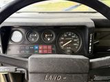 a steering wheel and gauges in a vehicle