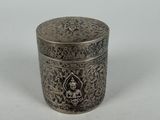 an antique silver box with a floral design on the lid