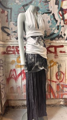 a mannequin in a room with graffiti on the wall