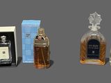 three bottles of perfume sitting next to each other on a table