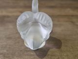 a small glass object sitting on a wooden table