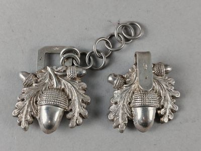 pair of silver acorns with leaves and acorns hanging from a chain