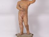 an antique statue of a boy on a pedestal with a raised hand